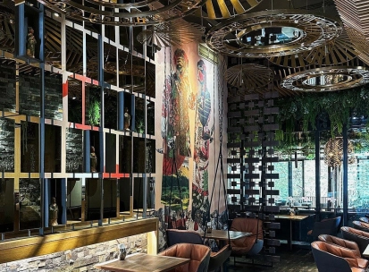 Restaurant Chary - large dining hall with a cultural mural and wire mesh screen dividers