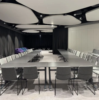 IQ Business Center in Kyiv- meeting room with U-shaped table setup and grey chairs