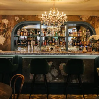 Etre Sofie - elegant, long bar counter featuring a prominent liquor display