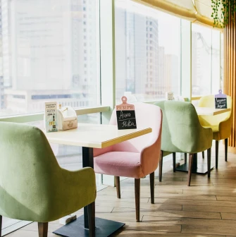 Pesto Cafe - sunlit dining area offering a wide panoramic view through large windows