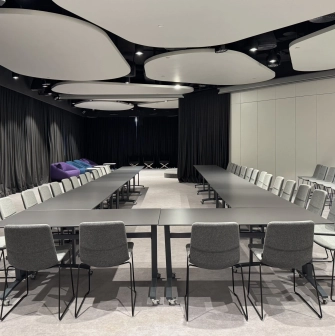 IQ Business Center in Kyiv- meeting room with U-shaped table setup and grey chairs