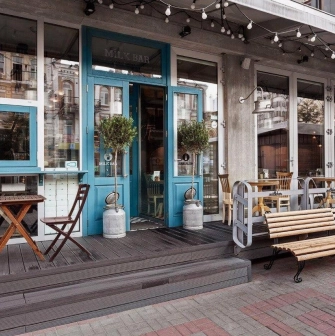Milk Bar - cafe facade with a large window and clear, minimal signage