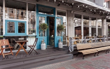 Milk Bar - cafe facade with a large window and clear, minimal signage