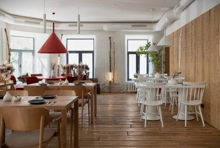 Restaurant 100 Rokiv Tomu Vpered - bright dining hall with white and light wood furniture