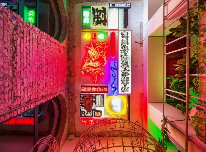 Restaurant Kytaiskyi Pryvit - colorful interior wall display of stacked neon signs and artwork