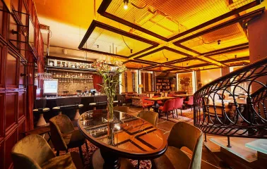 Restaurant Ostannia Barykada - lavish bar and lounge area with velvet chairs and spiral staircase