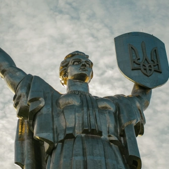 Motherland - majestic steel statue raising a sword and shield with a trident to the sky