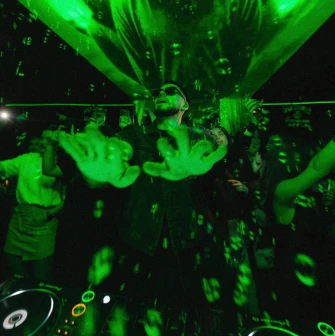 DJ at the Juice / NoCap club in Kyiv with lighting and projection above the stage