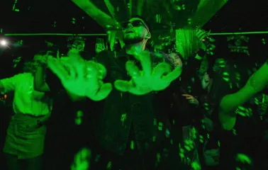 DJ at the Juice / NoCap club in Kyiv with lighting and projection above the stage