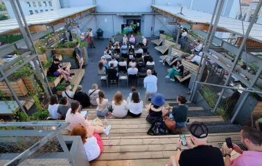 Kooperativ - cozy rooftop coworking area with scattered seating and city view