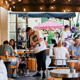 Fish Fetish - outdoor terrace seating area with wooden tables and chairs
