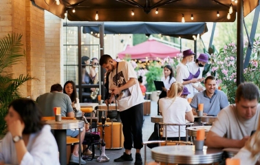 Fish Fetish - outdoor terrace seating area with wooden tables and chairs