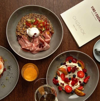 Top-down view of a breakfast spread with various dishes and a menu