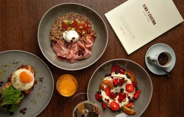 Top-down view of a breakfast spread with various dishes and a menu