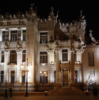 Budynok Horodetskoho in Kyiv - illuminated castle with mystical sculptures against the night sky