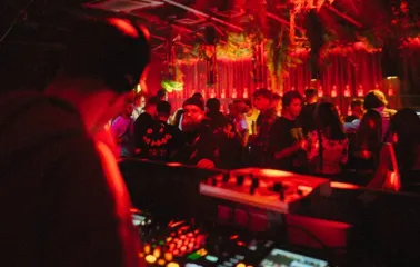 DJ at the console under the red light at Juice / NoCap club in Kyiv