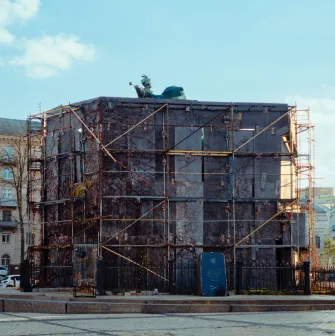 Monument to Bogdan Khmelnytsky in Kyiv - statue encased in massive protective scaffolding with only the mace visible