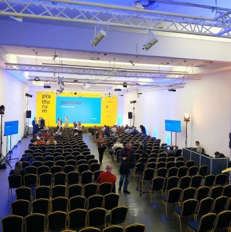 TSM m17 - modern conference setup with a stage, screen, and audience seating