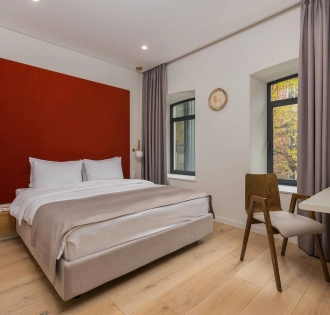 Sophia Hotel - close-up view of a large decorated bed with pillows