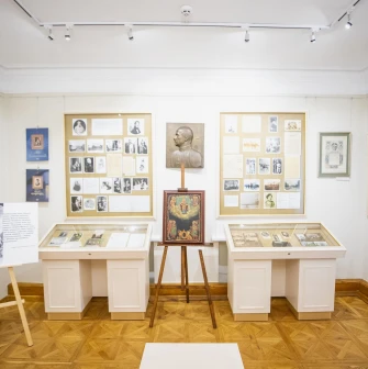 Muzei Hetmanstva in Kyiv - museum hall displaying a religious icon on a wooden easel surrounded by historical exhibits and portraits of Ukrainian leaders