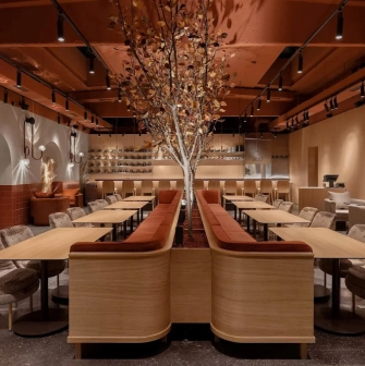 Zmist - stylish dining area with dark decor and decorated tree