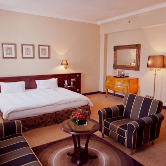 Opera Hotel - comfortable bed in a beautifully decorated room with dark wood