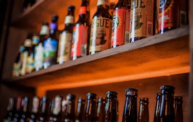 Pab Kedy - shelves lined with rows of bottled beer in a pub setting