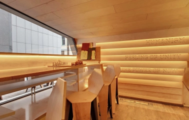 One Love Coffee in Kyiv - wooden interior corner with chess board by panoramic window