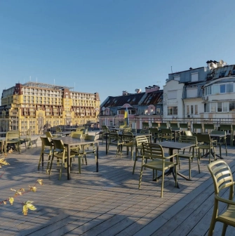 Bursa Hotel - casual outdoor cafe terrace with wooden tables and benches