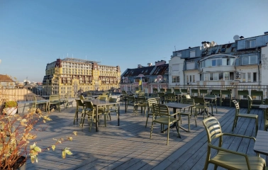 Bursa Hotel - casual outdoor cafe terrace with wooden tables and benches