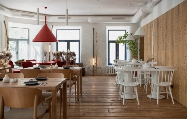 Restaurant 100 Rokiv Tomu Vpered - bright dining hall with white and light wood furniture