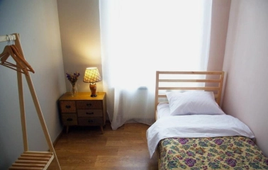 Single room with a wooden bed at Kashtan Guest House in Kyiv