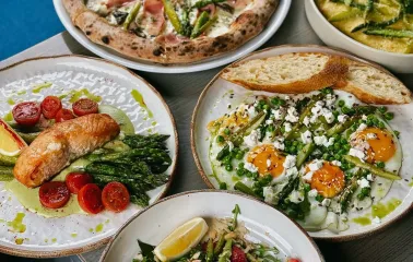 Restaurant Momenty - five plates of various spring dishes including pizza and salads