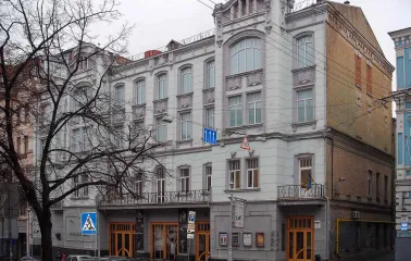 Molodyi Teatr in Kyiv - historic grey facade of the theater building on Prorizna street featuring intricate architectural stucco and arched windows
