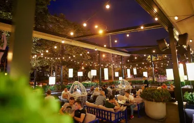 Par Bar - evening terrace with guests under string lights