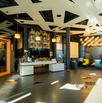 Modern lobby of the Mercure Kyiv Congress Hotel with a designer ceiling