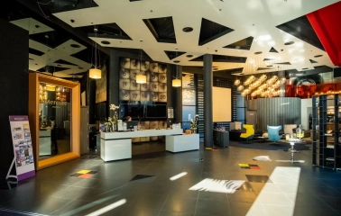 Modern lobby of the Mercure Kyiv Congress Hotel with a designer ceiling