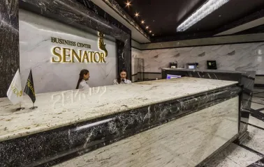Senator Business Center in Kyiv - marble reception desk with staff and golden logo