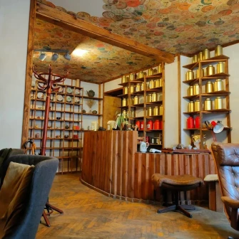 Chaguan in Kyiv - reception with wooden counter and ceiling covered in tea wrappers