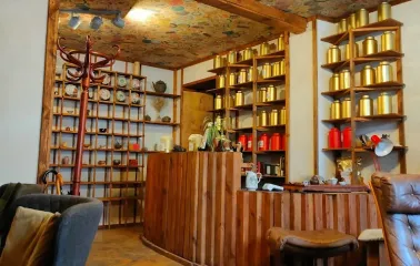 Chaguan in Kyiv - reception with wooden counter and ceiling covered in tea wrappers