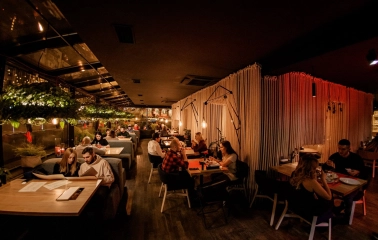 Restaurant Odesa - dark interior with dining guests and rope partitions