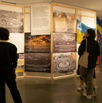 Muzei Istorii Mista Kyieva in Kyiv - visitors viewing a historical exhibition with large photos of the Maidan revolution