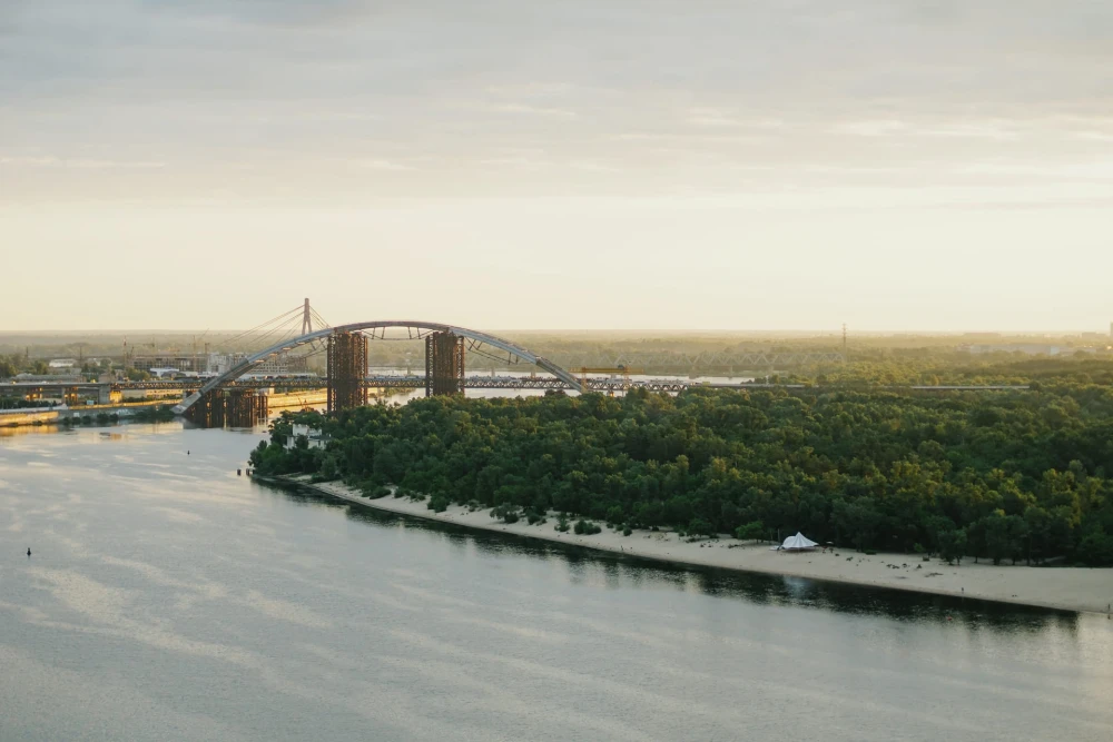View of the Podilsko-Voskresenskyi Bridge and the Dnipro River in Kyiv from the glass bridge
