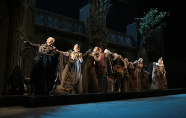 Teatr Lesi Ukrainky in Kyiv - theatrical performance with a group of actors in Renaissance costumes standing in a row against a backdrop of castle ruins