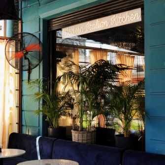 By Italy - veranda with dining tables and fan