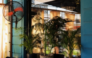 By Italy - veranda with dining tables and fan