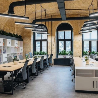 Coworking space with wooden tables and office chairs at Generator in Kyiv
