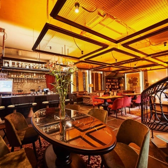 Restaurant Ostannia Barykada - lavish bar and lounge area with velvet chairs and spiral staircase