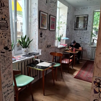 OG Burger in Kyiv - interior with graffiti walls and small tables