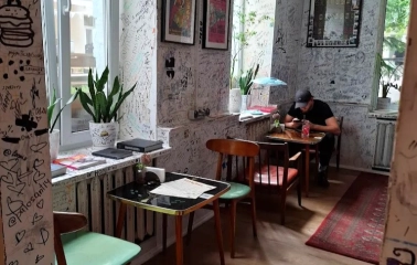 OG Burger in Kyiv - interior with graffiti walls and small tables